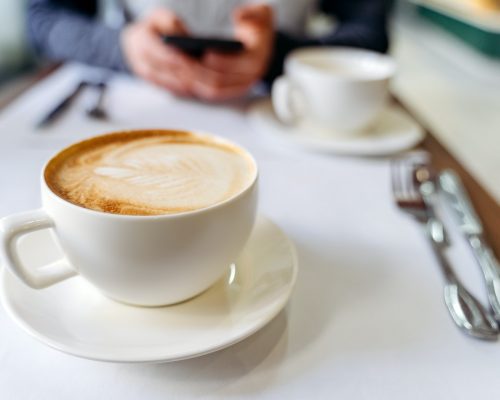 Cup with coffee on the table in a coffee shop.